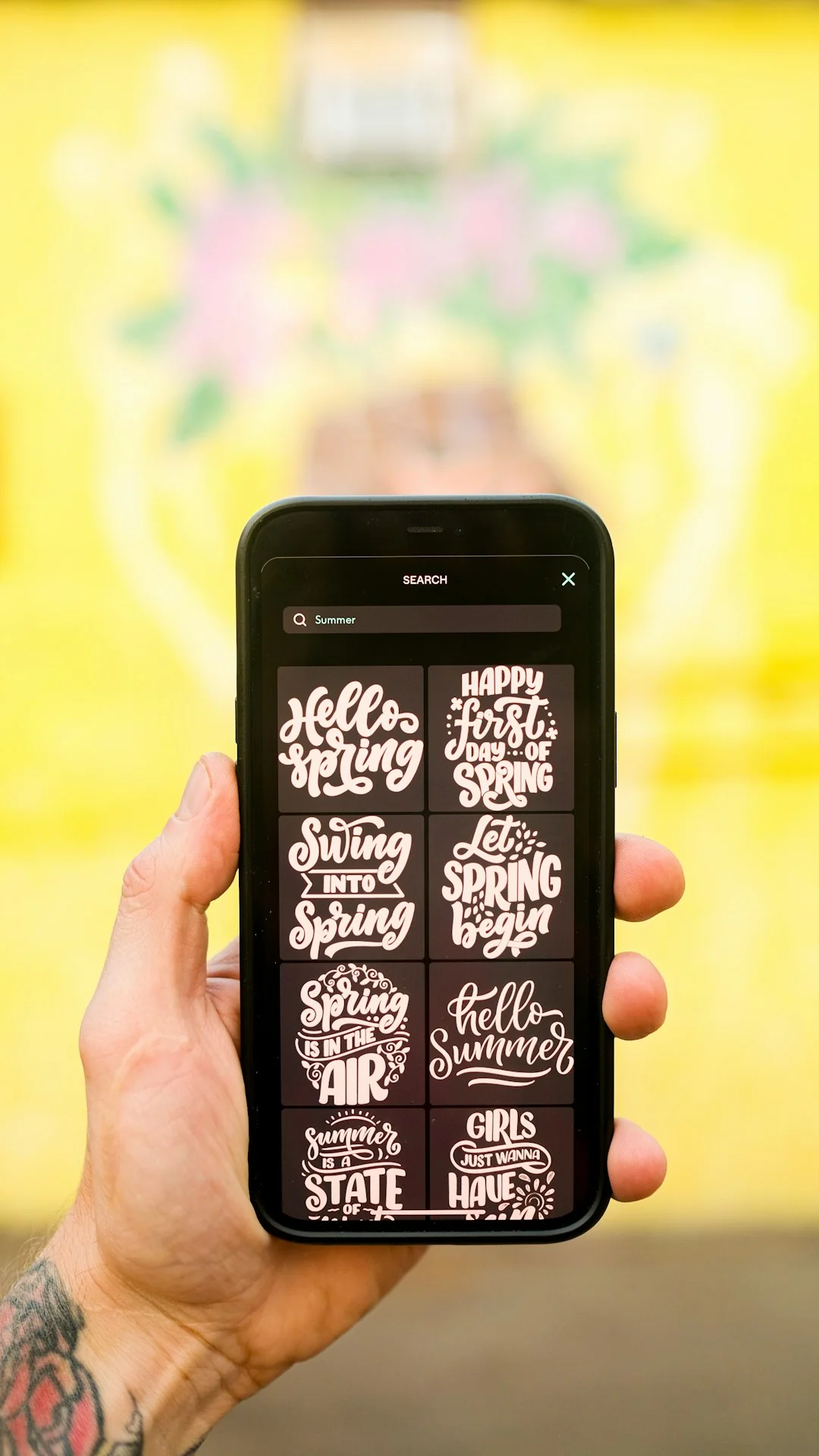A creative workspace featuring UI design plans, pencils, a smartphone, and other office tools.