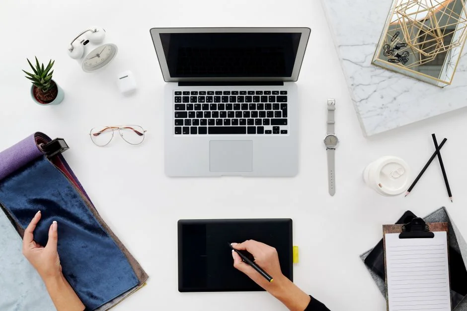 A stylish workspace featuring a laptop and monitors displaying design software.
